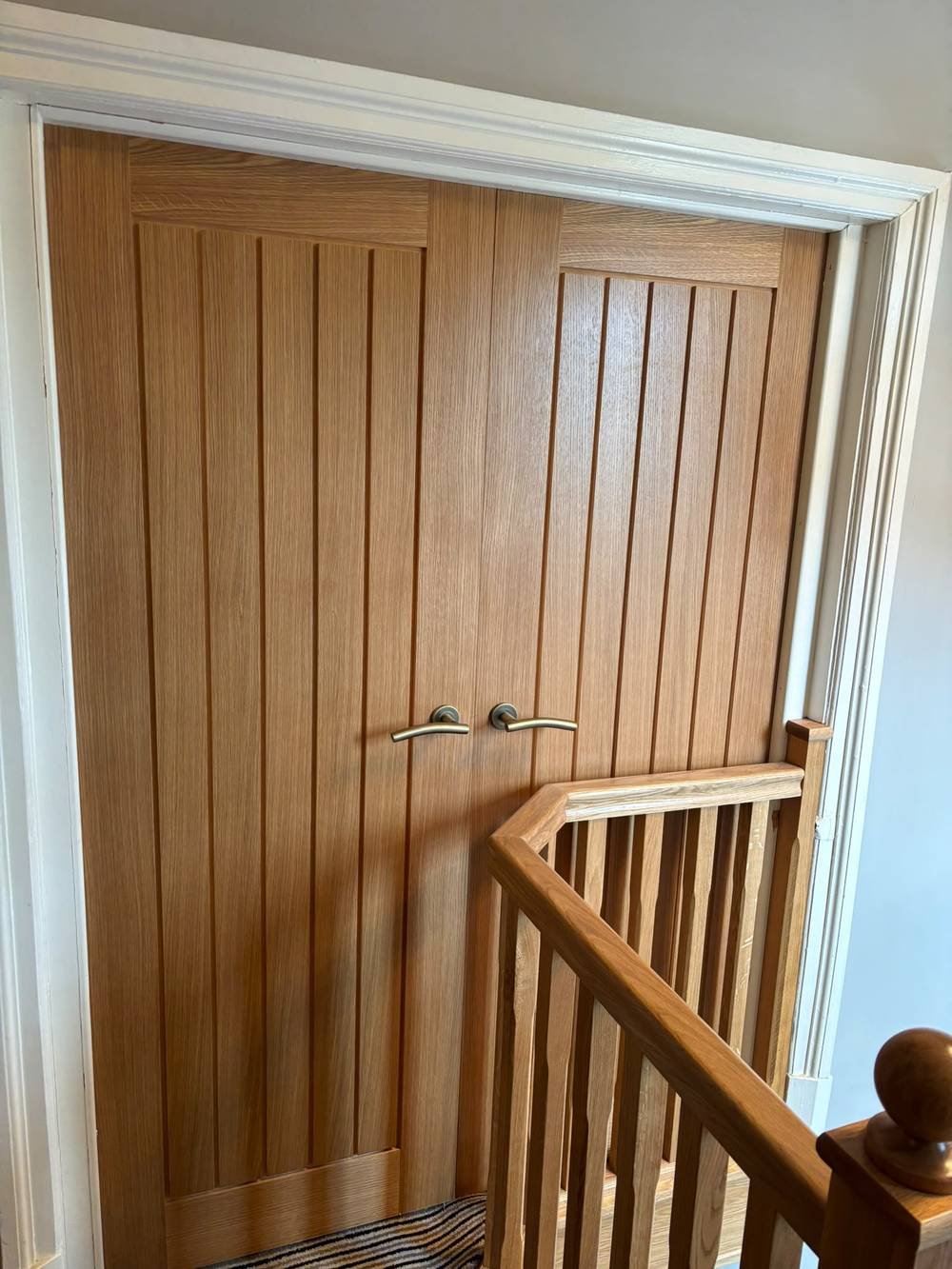 Double oak doors fitted at the top of a staircase landing