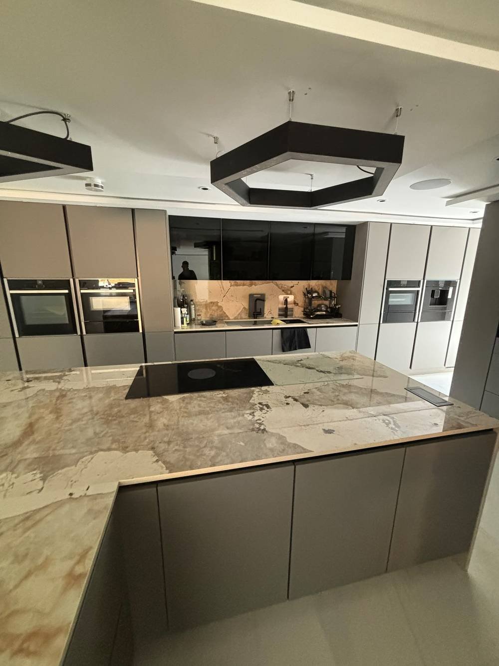 Fitted kitchen with integrated ovens and marble island