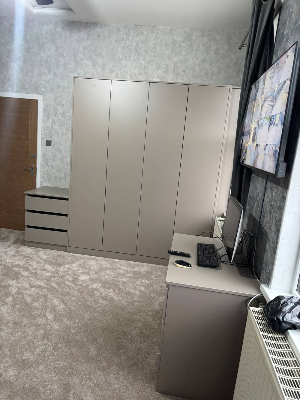 Fitted wardrobe with drawer units and desk space