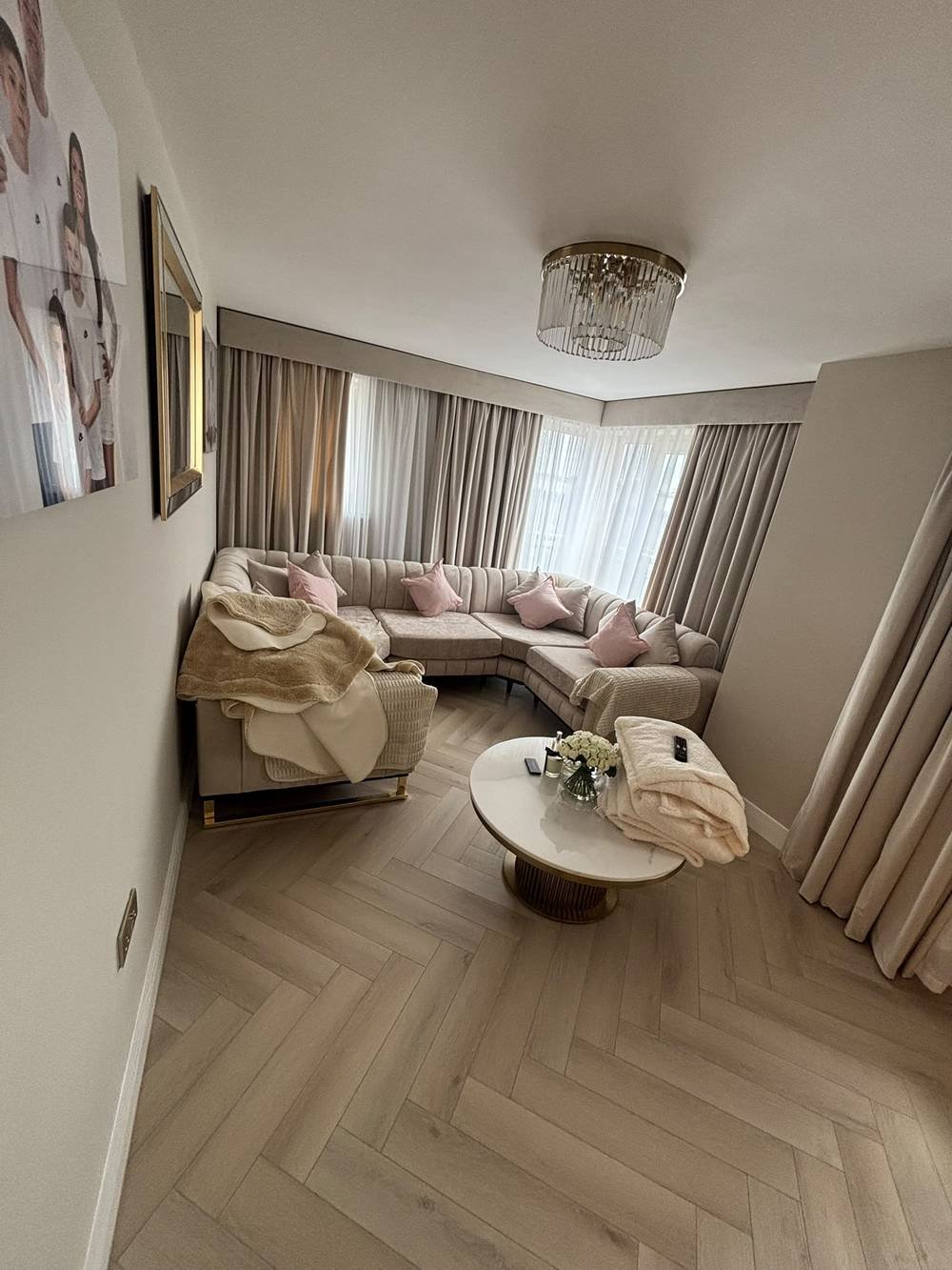 Herringbone flooring fitted in a luxury lounge with sectional sofa