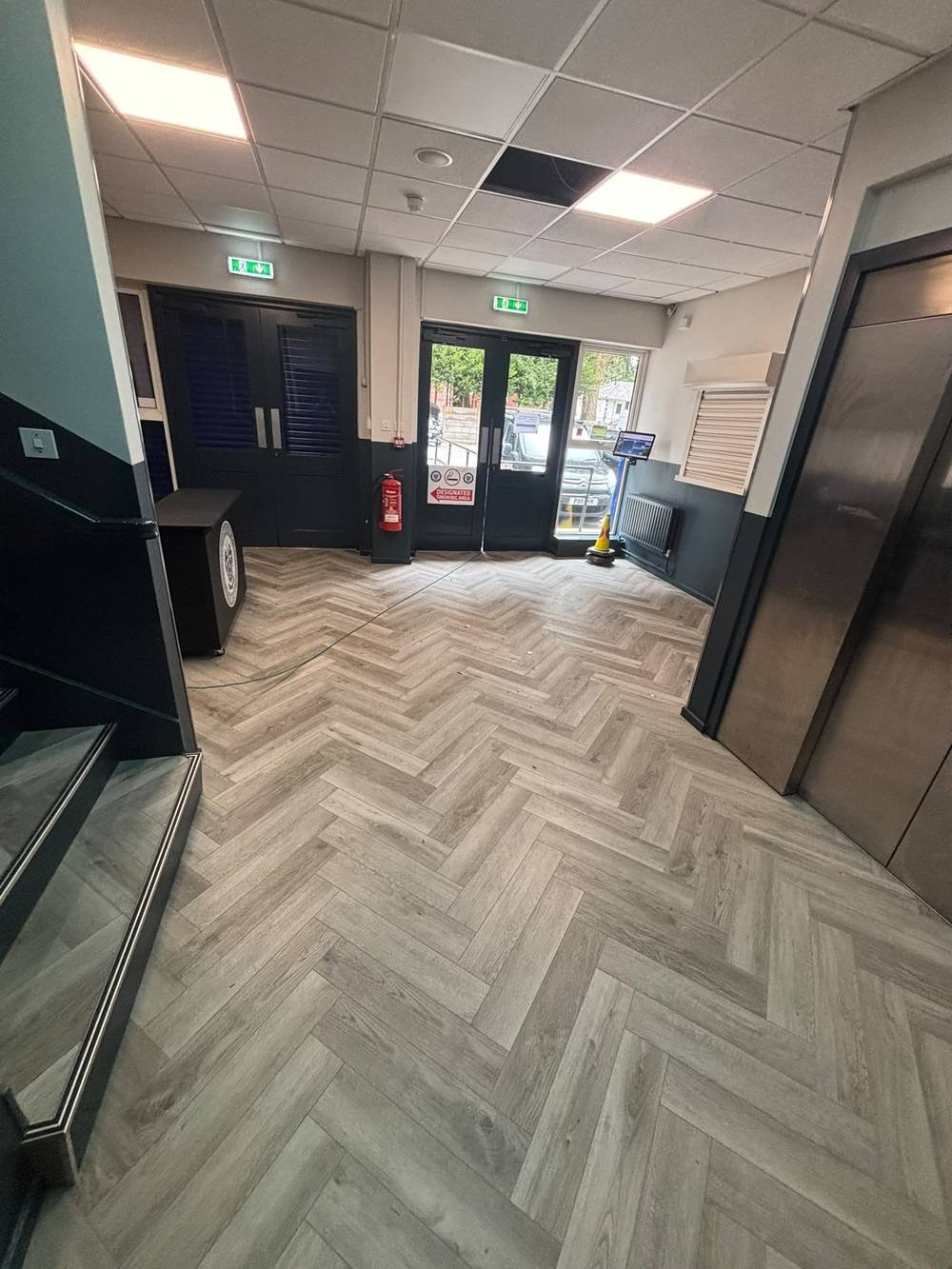 Herringbone flooring fitted in a stairwell and reception lobby