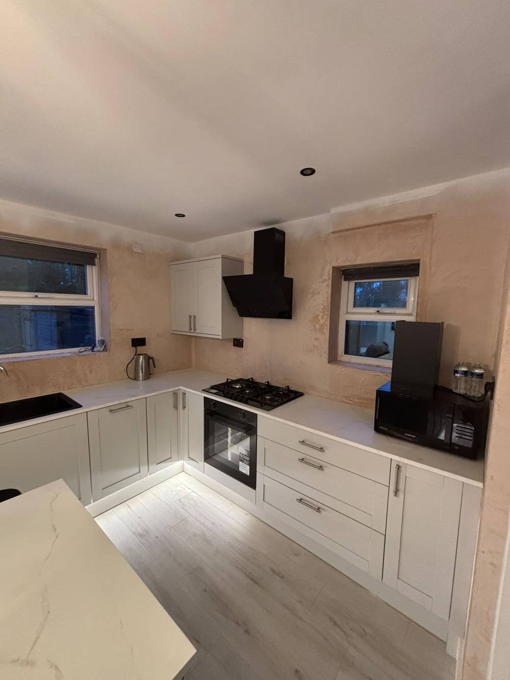 Kitchen fit-out mid-installation with extractor hood