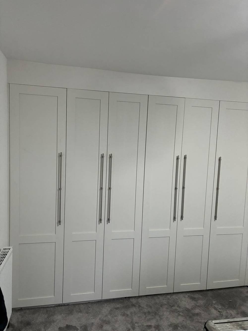White fitted wardrobes with panelled doors