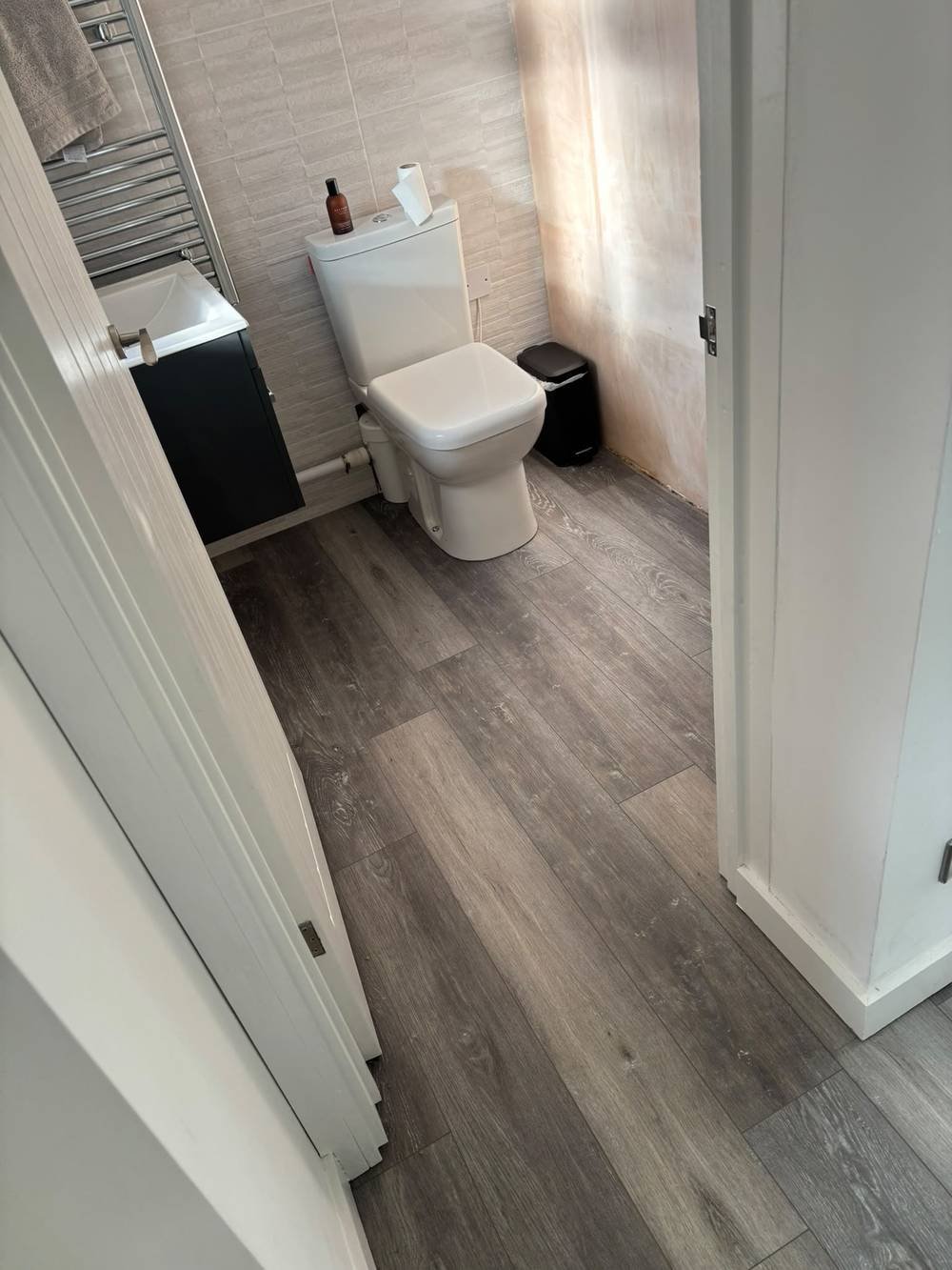 Wood-effect vinyl flooring fitted in a bathroom